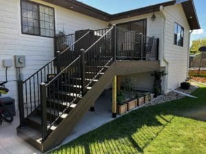 wooden back deck patio with stairs and metal railing