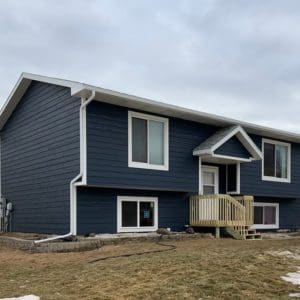 Residential home with new navy blue siding